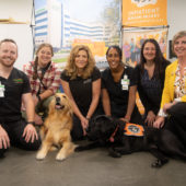 Recreational therapy team at Mary Free Bed smile with animal-assisted therapy dogs from Paws with a Cause