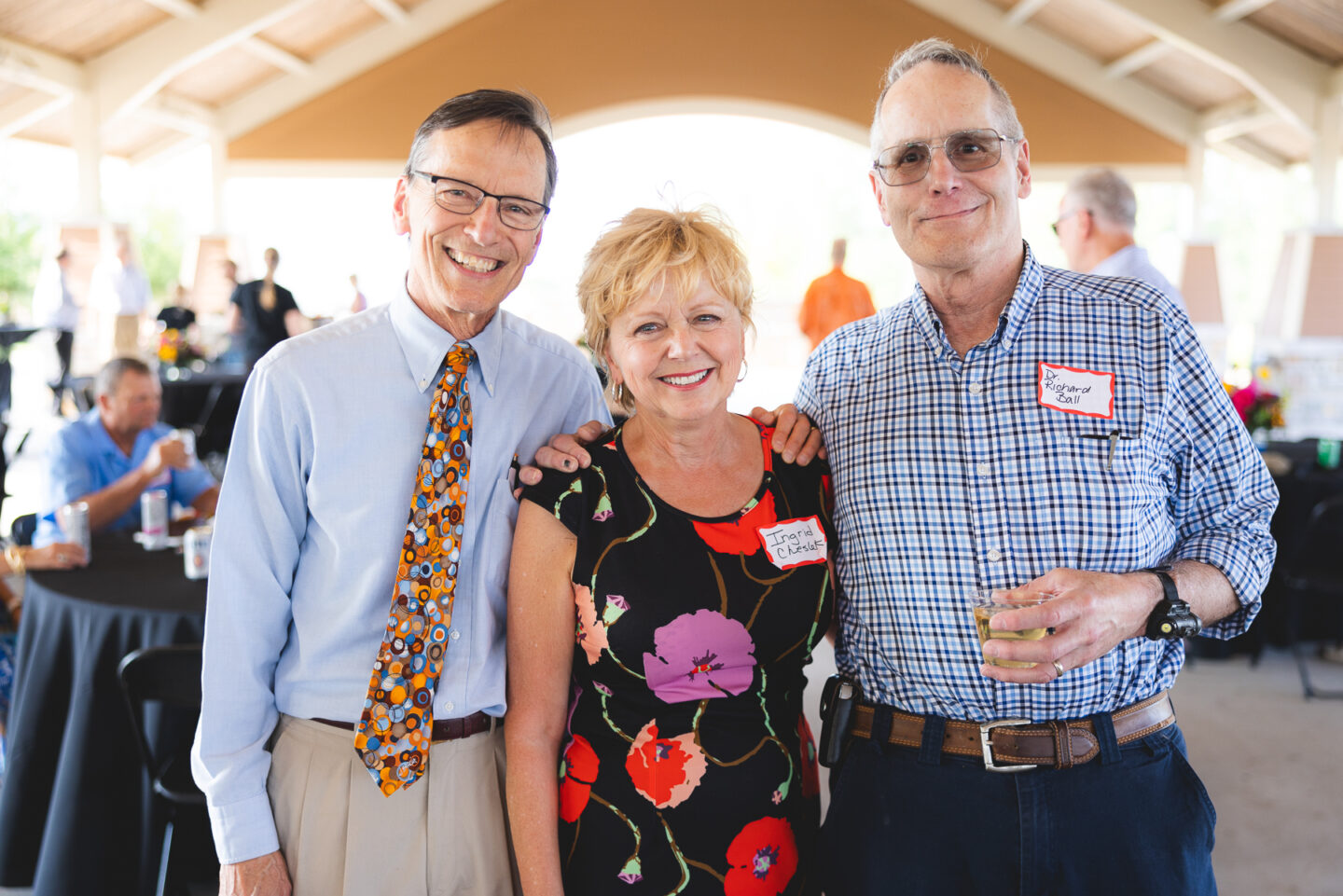 Three long time Mary Free Bed leaders smile together at their retirement party from Mary Free Bed