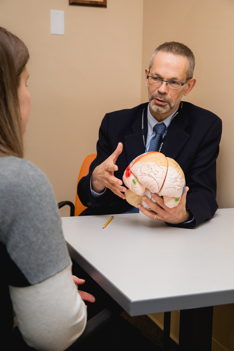 Neuropsychologist explaining brain anatomy and function during a cognitive rehabilitation session at Mary Free Bed.