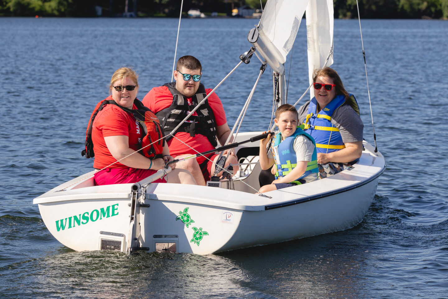 A family aboard a sailboat participates in Mary Free Bed Adaptive Sports sailing clinic.