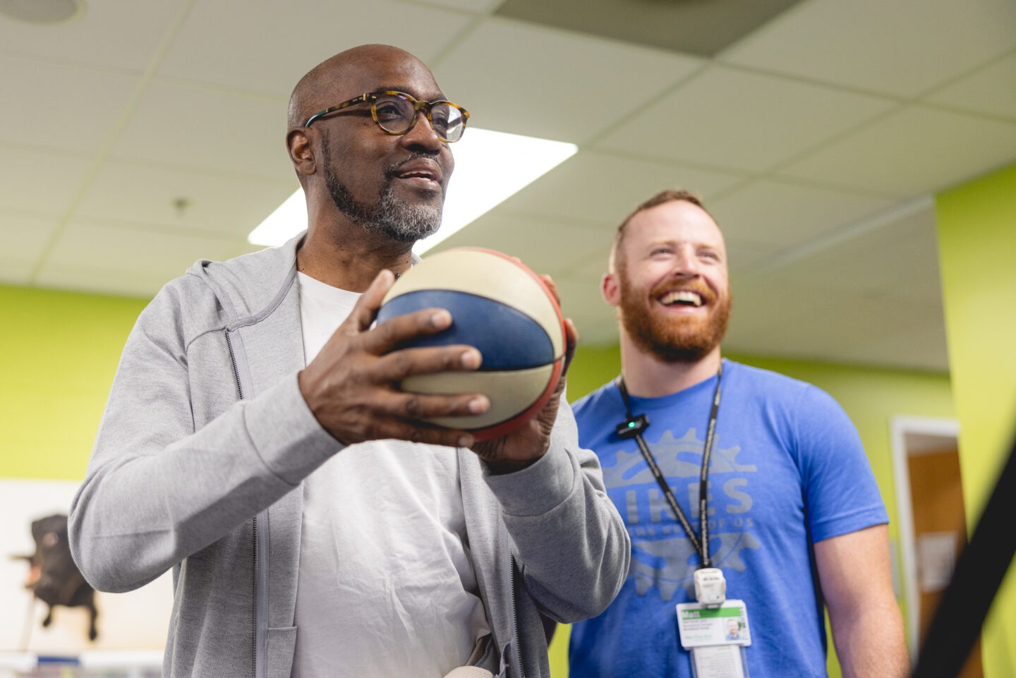 Stroke Patient in Recreational Therapy shooting basketball